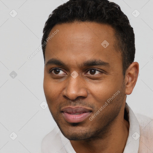 Joyful black young-adult male with short  black hair and brown eyes