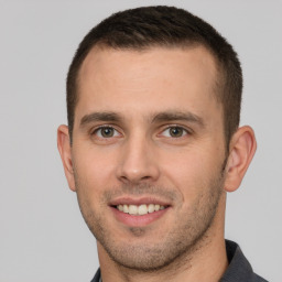 Joyful white young-adult male with short  brown hair and brown eyes