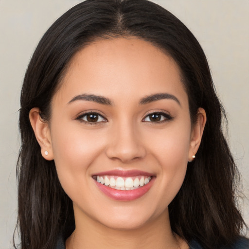 Joyful white young-adult female with long  brown hair and brown eyes