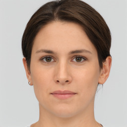 Joyful white young-adult female with short  brown hair and brown eyes