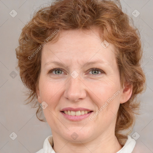 Joyful white adult female with medium  brown hair and blue eyes