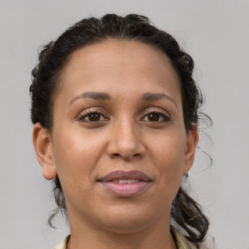 Joyful latino adult female with short  brown hair and brown eyes
