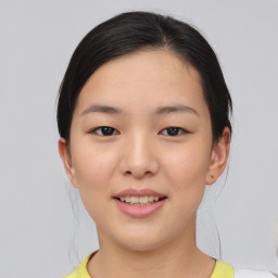 Joyful asian young-adult female with medium  brown hair and brown eyes