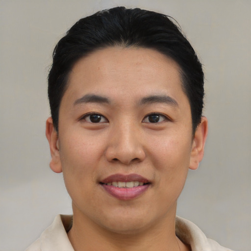 Joyful asian young-adult male with short  black hair and brown eyes