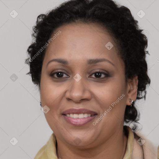 Joyful black adult female with long  brown hair and brown eyes