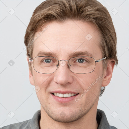 Joyful white adult male with short  brown hair and grey eyes