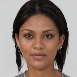 Joyful black young-adult female with medium  brown hair and brown eyes