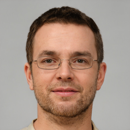 Joyful white adult male with short  brown hair and green eyes