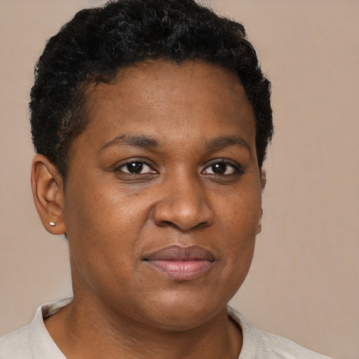 Joyful black young-adult female with short  brown hair and brown eyes