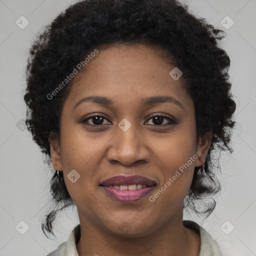 Joyful black adult female with short  brown hair and brown eyes