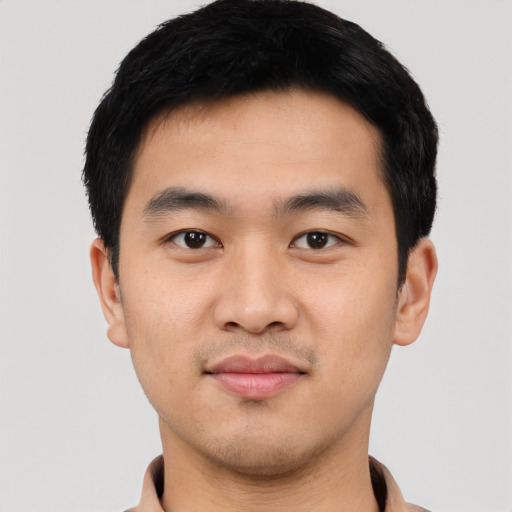 Joyful asian young-adult male with short  black hair and brown eyes