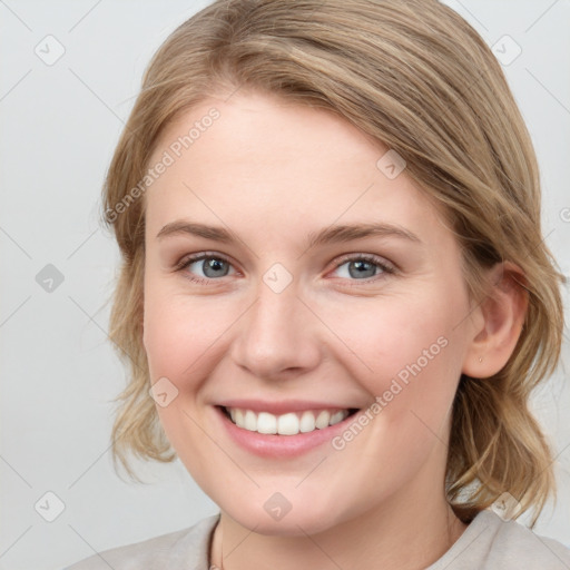 Joyful white young-adult female with medium  brown hair and blue eyes