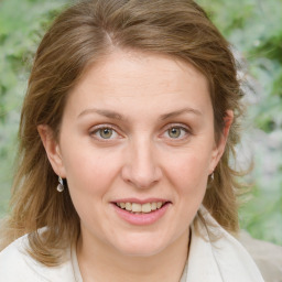 Joyful white adult female with medium  brown hair and blue eyes