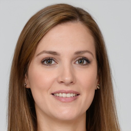 Joyful white young-adult female with long  brown hair and green eyes