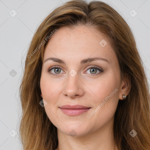 Joyful white young-adult female with long  brown hair and green eyes