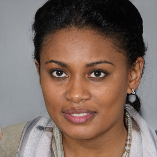 Joyful black young-adult female with short  brown hair and brown eyes