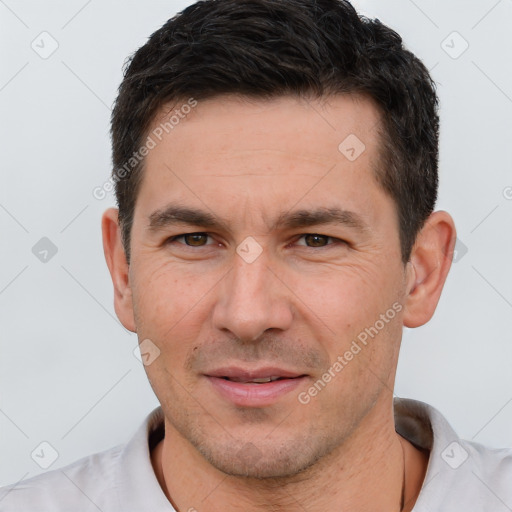 Joyful white adult male with short  brown hair and brown eyes