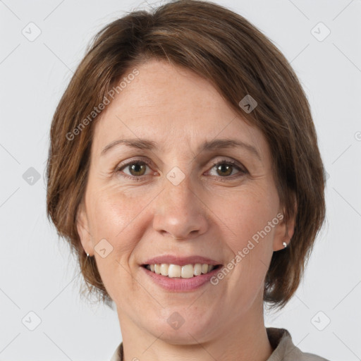 Joyful white adult female with medium  brown hair and grey eyes