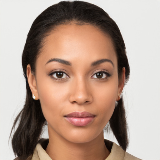 Joyful latino young-adult female with long  brown hair and brown eyes