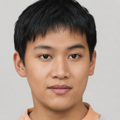 Joyful asian young-adult male with short  brown hair and brown eyes