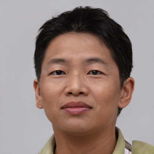 Joyful asian adult male with short  brown hair and brown eyes
