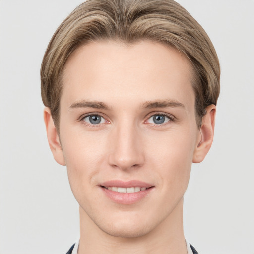 Joyful white young-adult male with short  brown hair and grey eyes