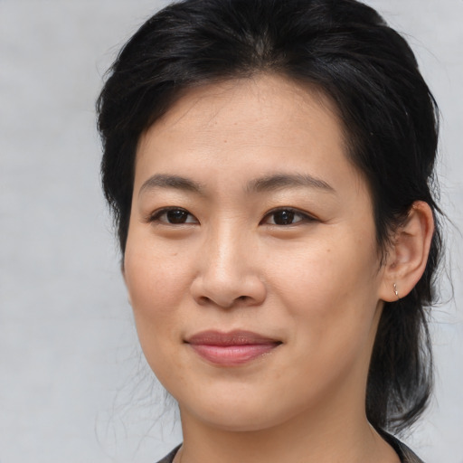 Joyful asian young-adult female with medium  brown hair and brown eyes