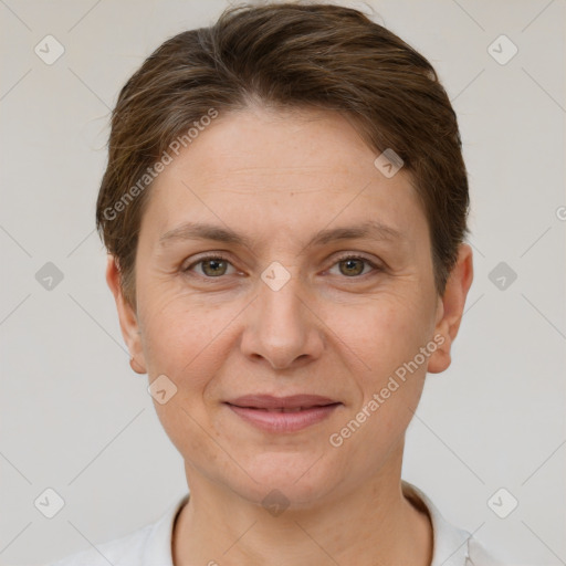 Joyful white adult female with short  brown hair and grey eyes