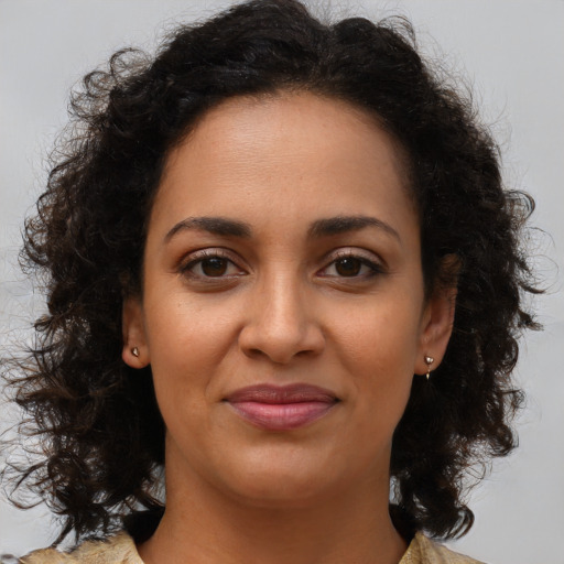 Joyful black young-adult female with medium  brown hair and brown eyes