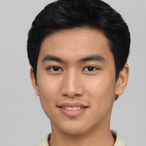 Joyful asian young-adult male with short  brown hair and brown eyes