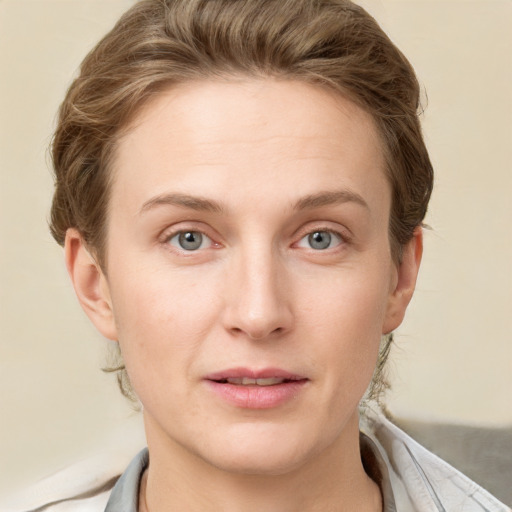 Joyful white young-adult female with short  brown hair and grey eyes