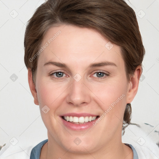 Joyful white young-adult female with short  brown hair and grey eyes