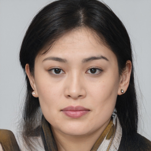 Joyful asian young-adult female with medium  brown hair and brown eyes