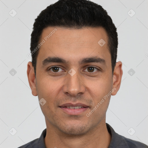 Joyful white young-adult male with short  black hair and brown eyes