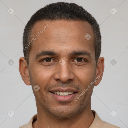 Joyful latino young-adult male with short  brown hair and brown eyes