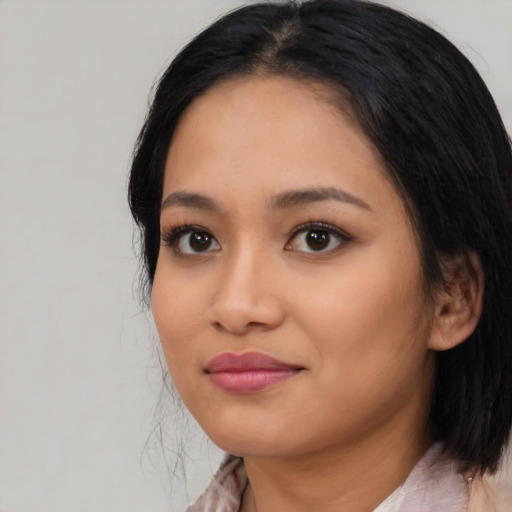 Joyful asian young-adult female with medium  black hair and brown eyes