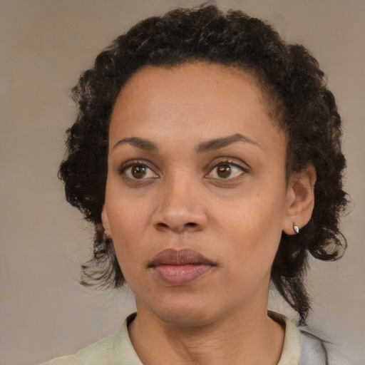 Neutral black young-adult female with medium  brown hair and brown eyes