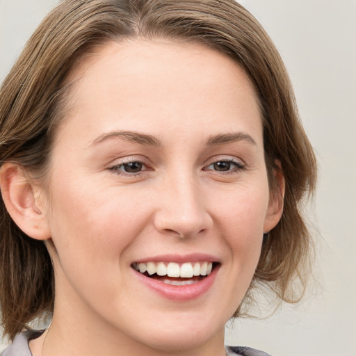 Joyful white young-adult female with medium  brown hair and blue eyes