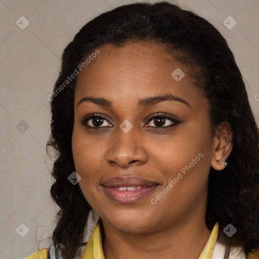 Joyful black young-adult female with long  brown hair and brown eyes