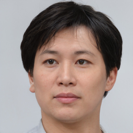 Neutral asian adult male with short  brown hair and brown eyes