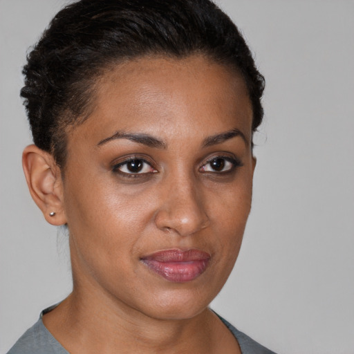 Joyful black young-adult female with short  brown hair and brown eyes