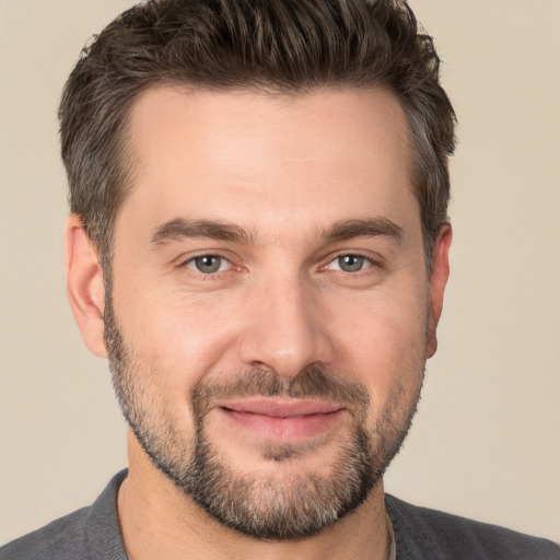 Joyful white adult male with short  brown hair and brown eyes