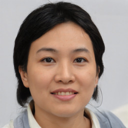 Joyful asian young-adult female with medium  black hair and brown eyes