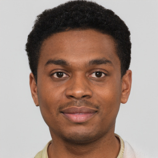 Joyful black young-adult male with short  brown hair and brown eyes