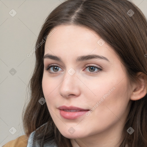 Neutral white young-adult female with long  brown hair and brown eyes