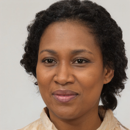 Joyful black adult female with medium  black hair and brown eyes