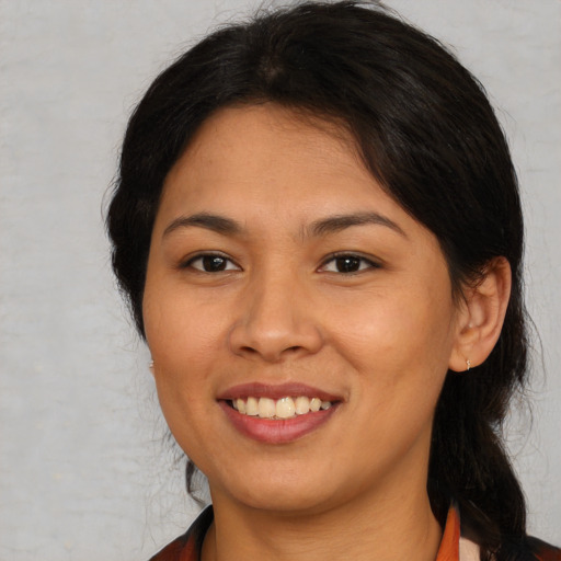 Joyful asian young-adult female with medium  brown hair and brown eyes