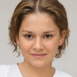 Joyful white child female with medium  brown hair and brown eyes