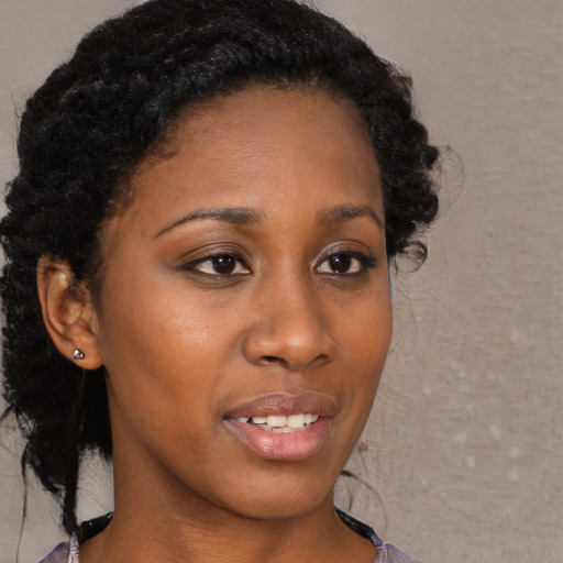 Joyful black young-adult female with medium  brown hair and brown eyes