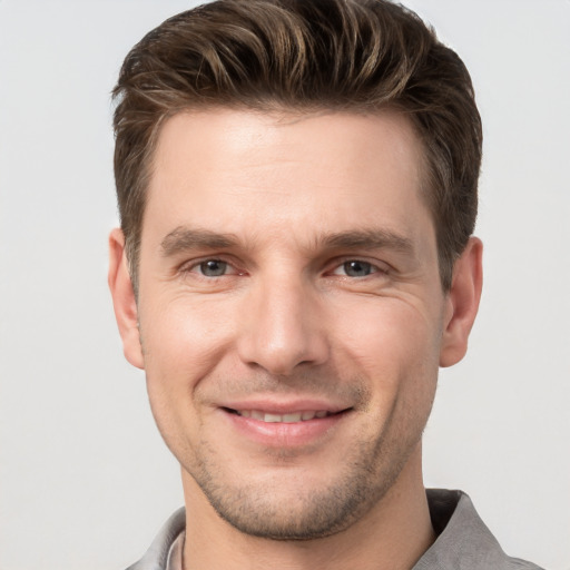 Joyful white young-adult male with short  brown hair and brown eyes